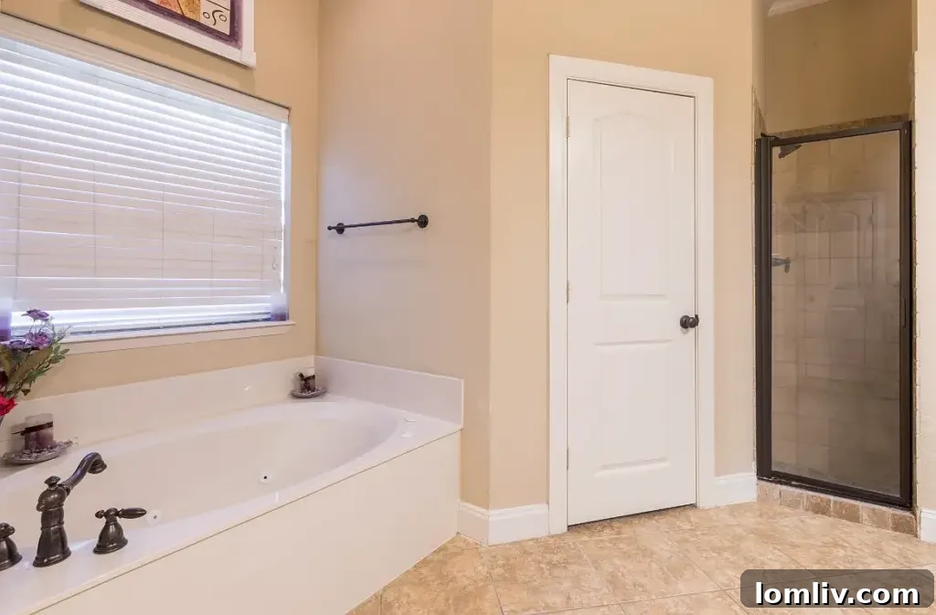 Spa-like master bathroom with soaking tub and separate shower at 7301 Granville Drive