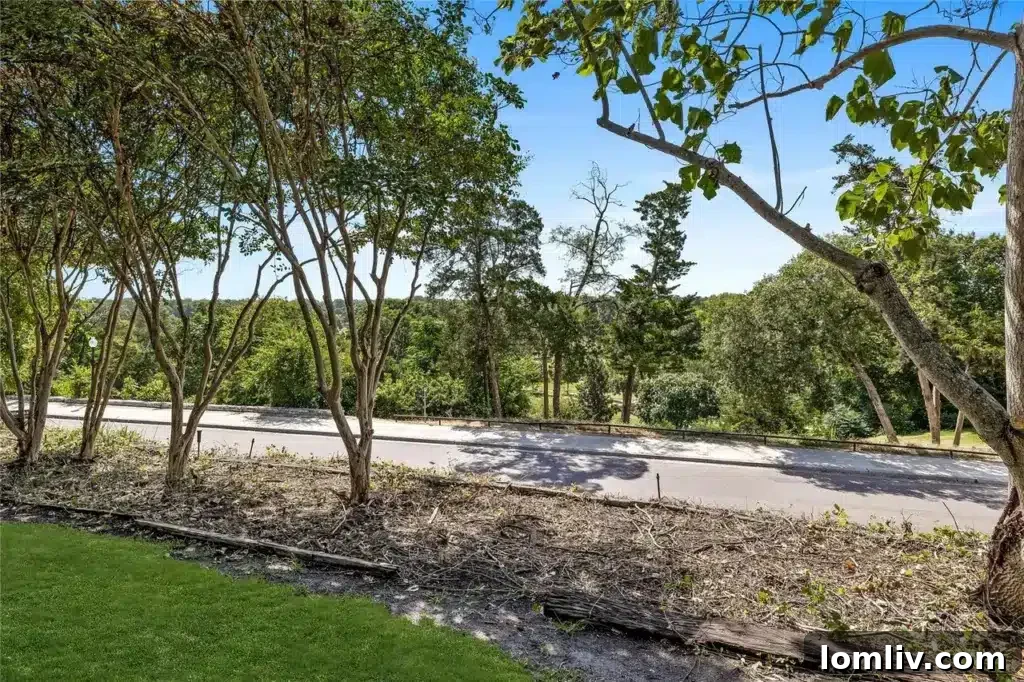 The cleared backyard of the Plymouth Road home, offering stunning, unobstructed views of the lush Stevens Park Golf Course.