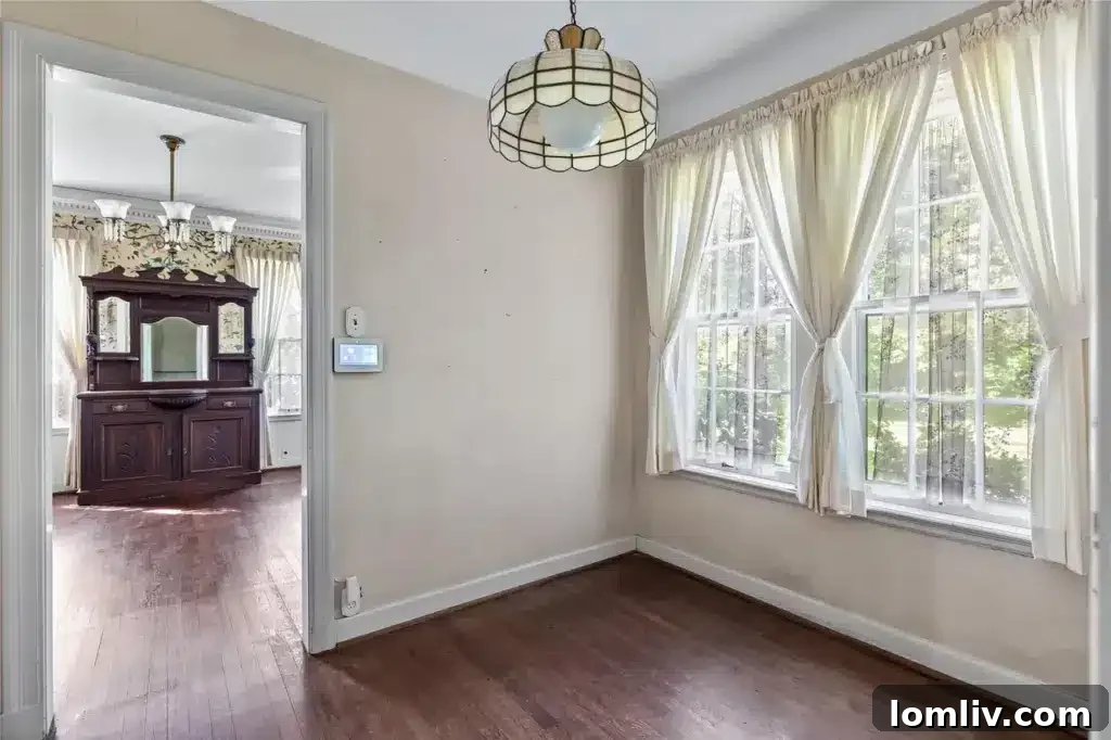 Another interior view, possibly a dining area or a study, with traditional furnishings and ample natural light.