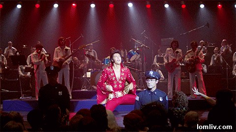 Elvis Presley wearing a saucer-shaped cape