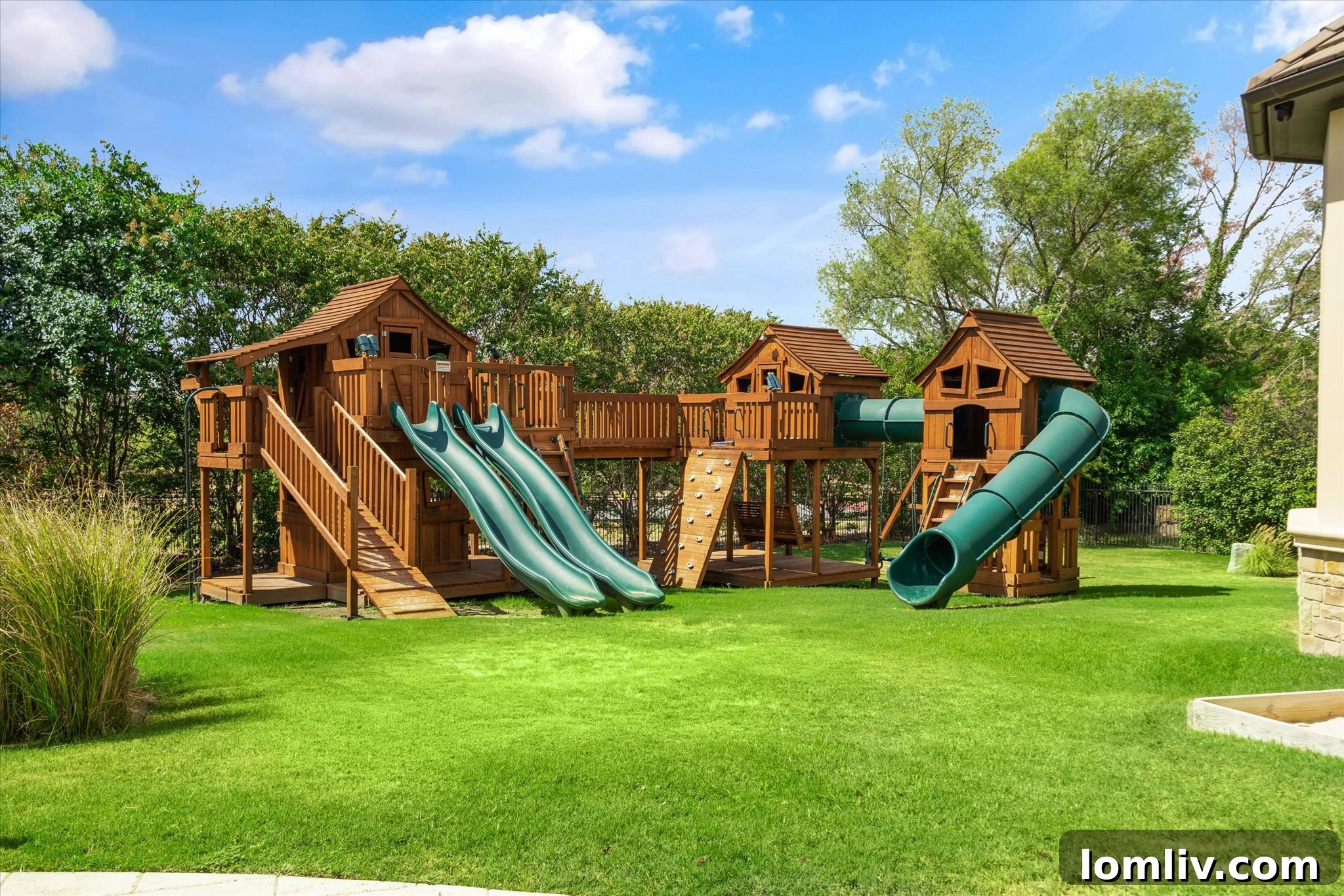 Children's playground set within a lush, spacious backyard, part of a luxury family home.