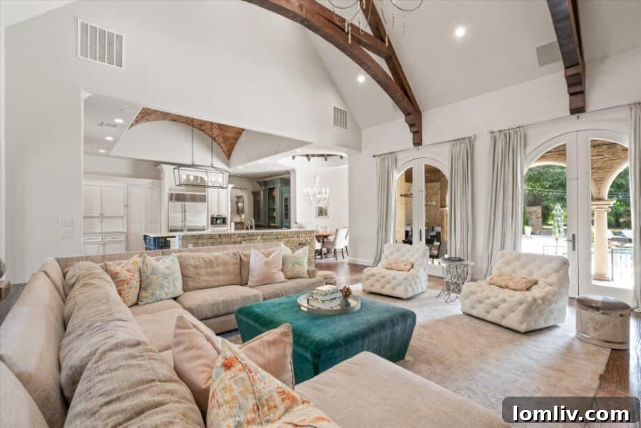 Elegant living room with French doors opening to an outdoor patio in a luxury home.