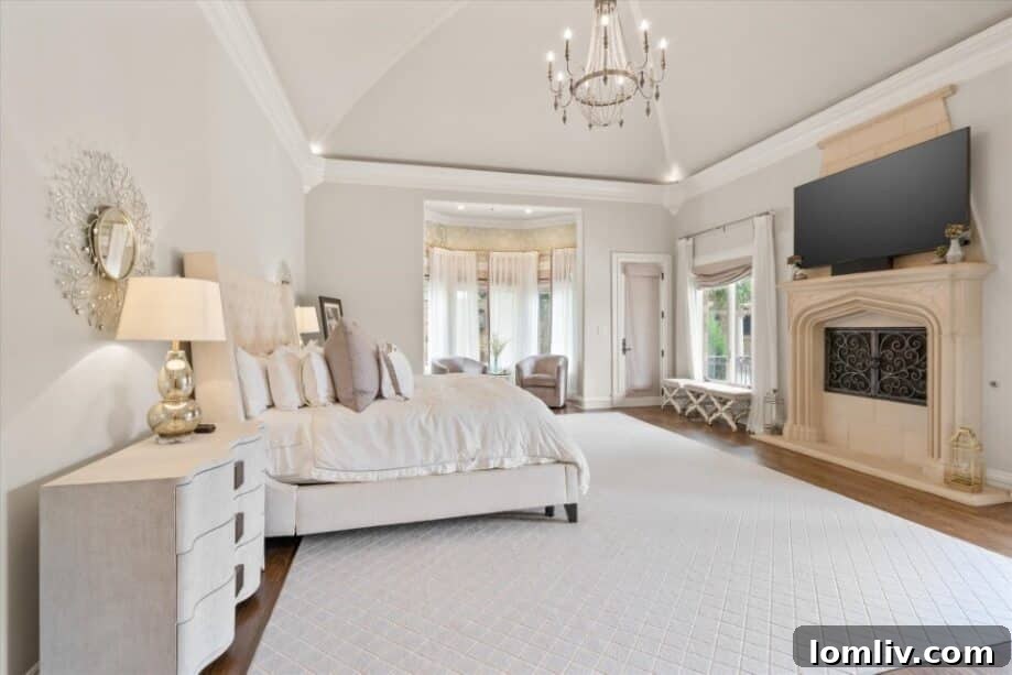 Cozy primary bedroom with a fireplace and elegant furnishings.
