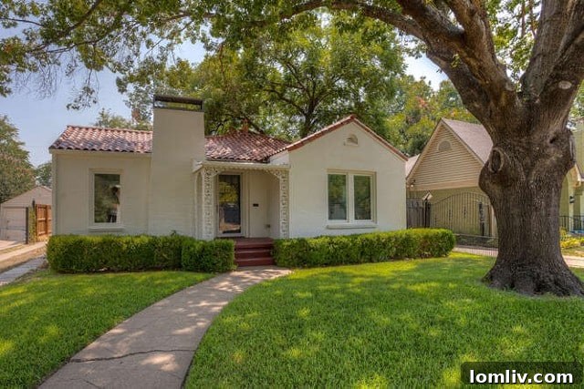 Large, mature tree shading a charming Mediterranean-style bungalow near TCU in Fort Worth