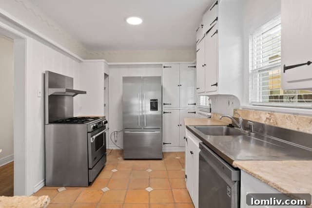 Updated kitchen with stainless steel appliances and abundant storage in a Mediterranean bungalow