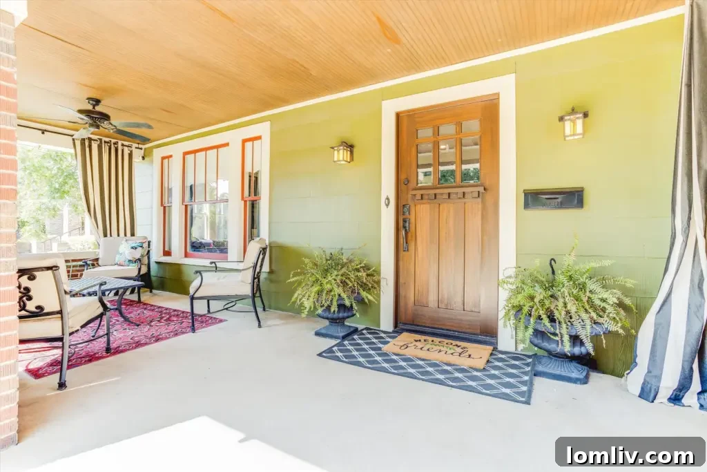 Fort Worth Craftsman A Colorful Renovation Fueled by Love 3 Inviting front porch of a restored vintage home with lush landscaping