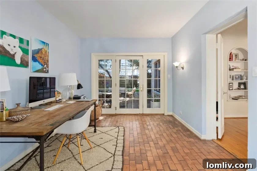 Close-up of Spanish Colonial Revival architecture details: stucco, arched windows, and red tile roof