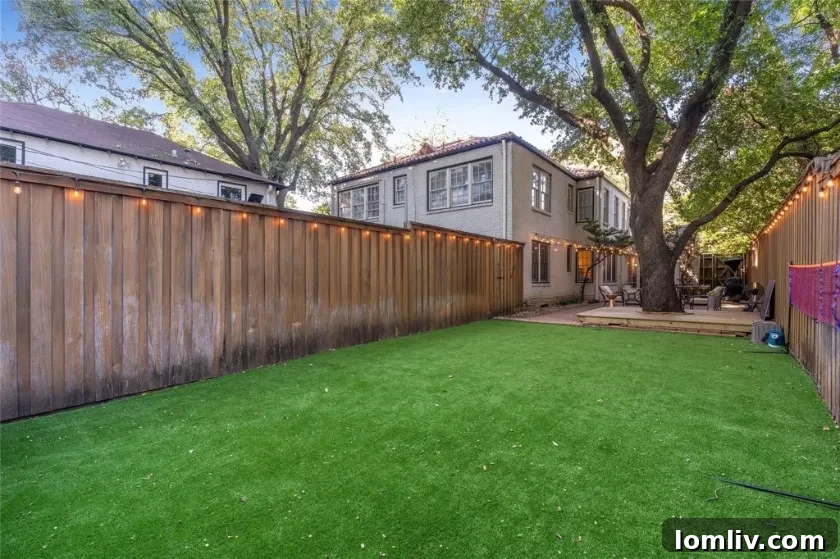 Exterior view of the backyard and garage apartment with artificial turf and private courtyard elements