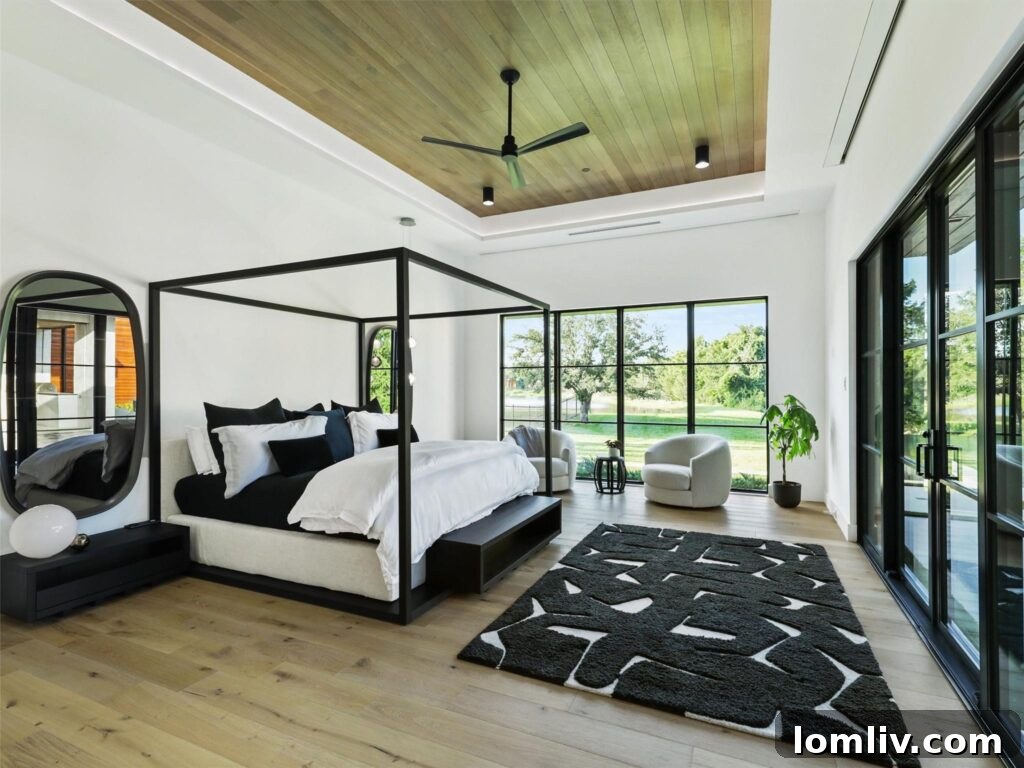 Westlake's Quail Hollow: Redefining Modern Luxury 15 Luxurious primary bedroom with lake views and high ceilings.