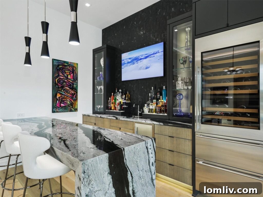 Westlake's Quail Hollow: Redefining Modern Luxury 17 Elegant game room with a wet bar featuring black and white marble countertops.