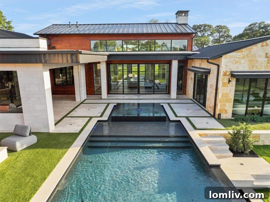 Westlake's Quail Hollow: Redefining Modern Luxury 20 Outdoor living space with multiple seating areas overlooking the pool and lake.