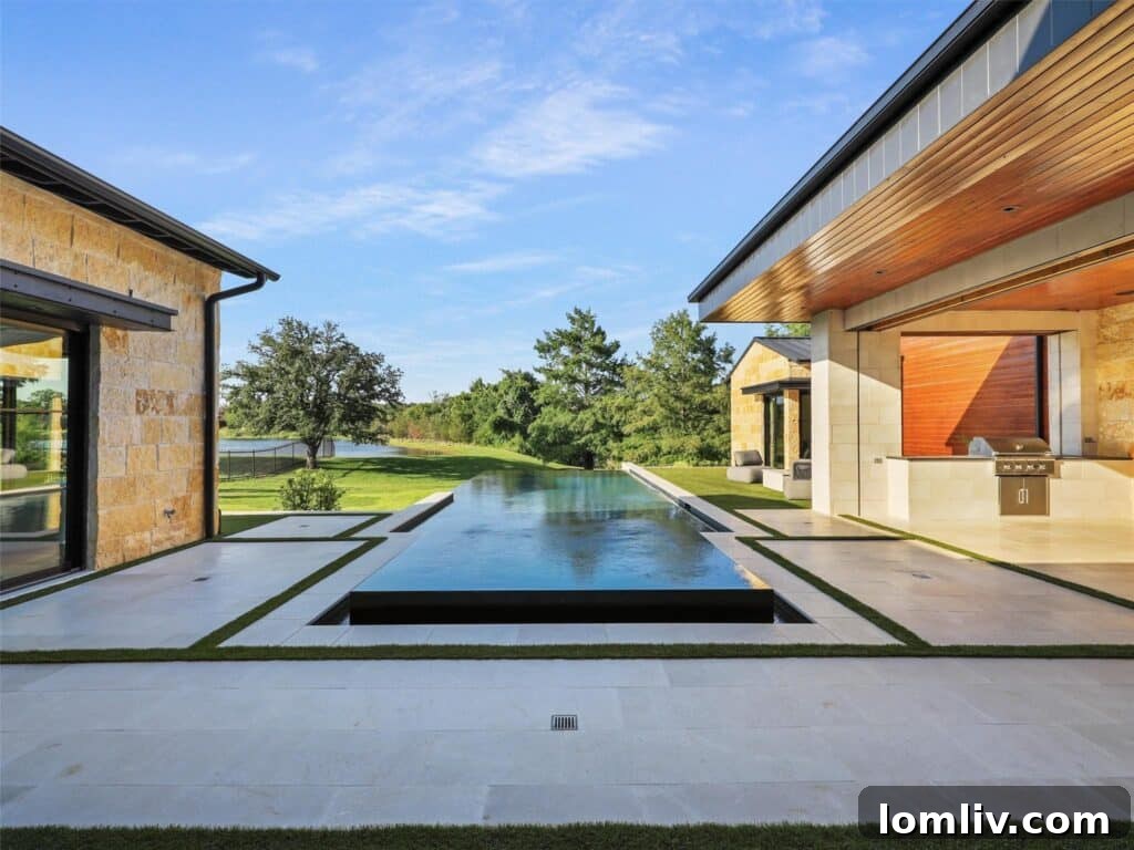 Westlake's Quail Hollow: Redefining Modern Luxury 21 Stunning infinity-edge pool by Claffey, overlooking the tranquil lake at 1714 Cypress Way.