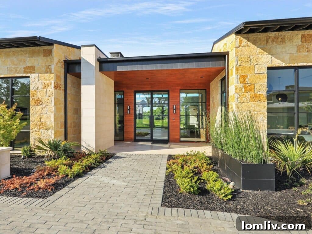 Westlake's Quail Hollow: Redefining Modern Luxury 6 Expansive living area with floor-to-ceiling windows and a view of the infinity pool and lake.