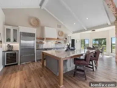 Expansive gourmet kitchen with a large island in an Aubrey home, perfect for preparing and serving game day refreshments.