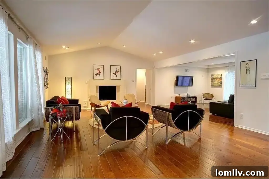 Spacious open-concept living room with a large screen TV in a Dallas home, ideal for a football viewing party.