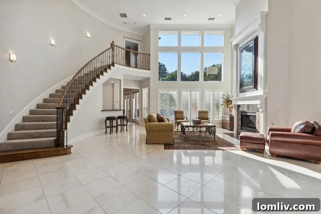Wide view of the home's grand entrance and contemporary white stone exterior.