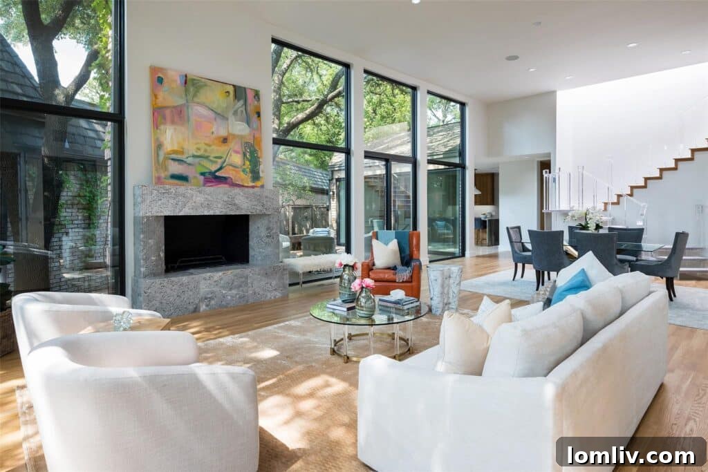 Luxurious living room in the North Dallas home featuring a fluted Danby marble mantel over the fireplace, with large windows overlooking the lake.