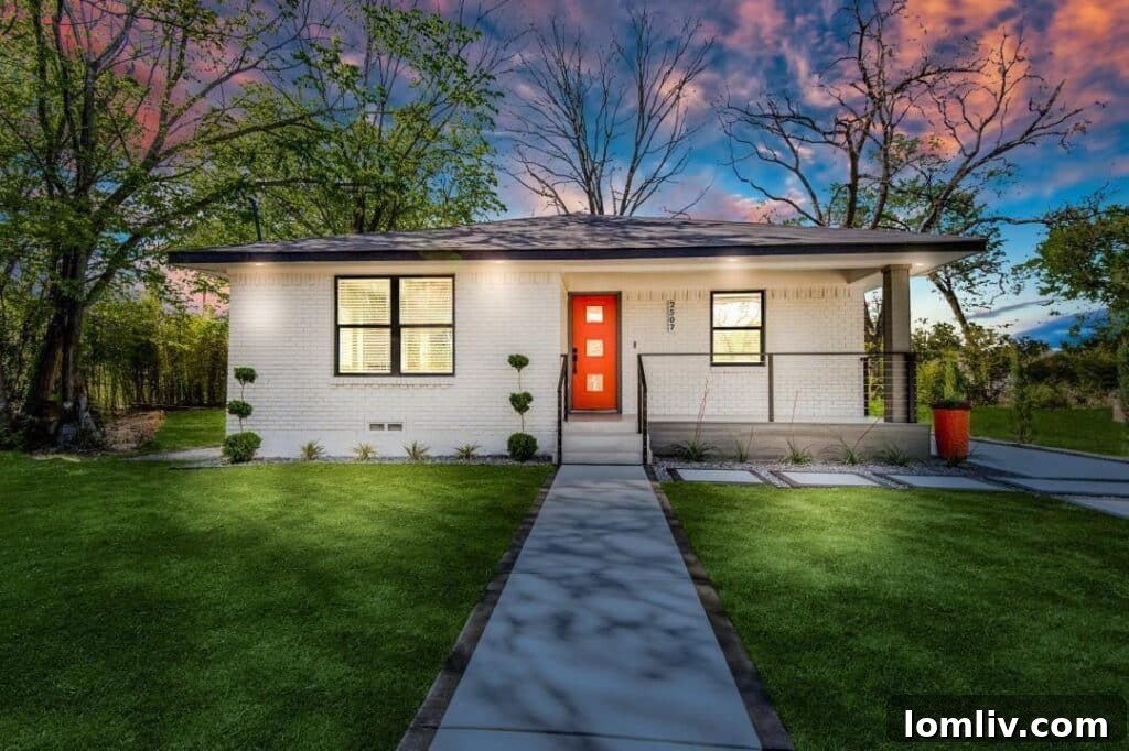 Vibrant orange front door of a beautifully renovated home in South Dallas, symbolizing community renewal.
