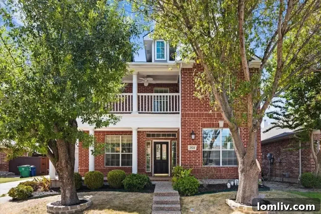 Red brick house with white trim and a balcony, offering appealing curb appeal in McKinney.