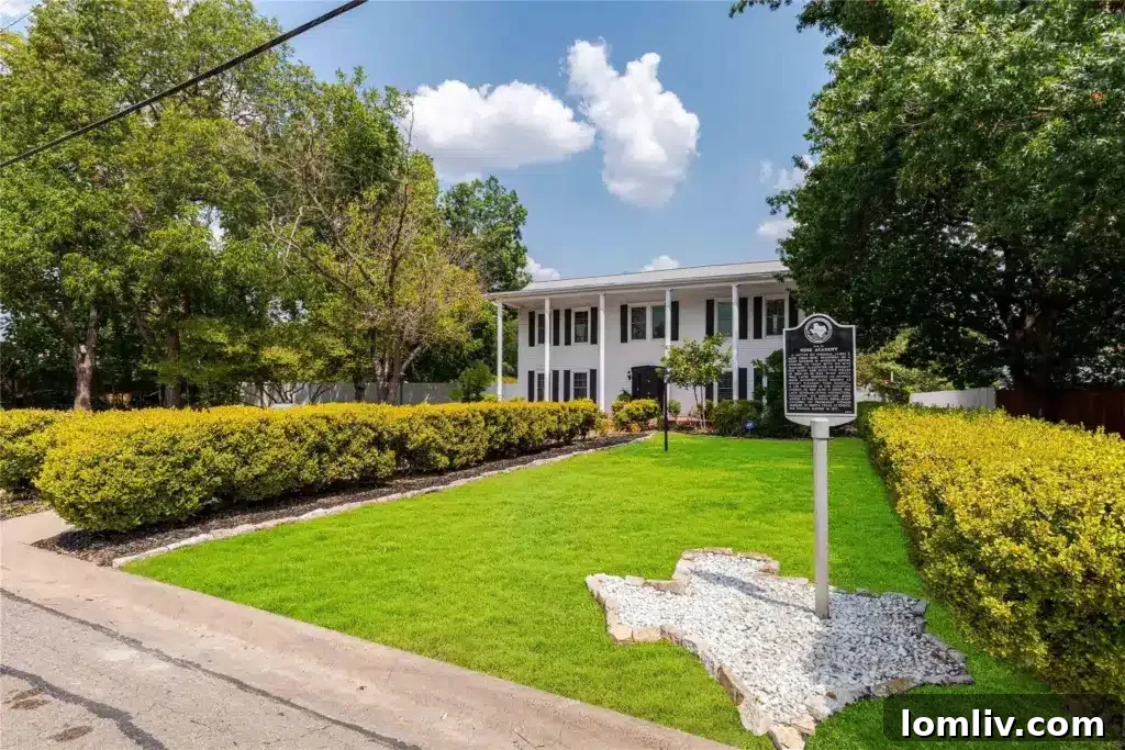 Historic 1858 McKinney home for sale, showcasing elegant colonial columns and a wide front porch.