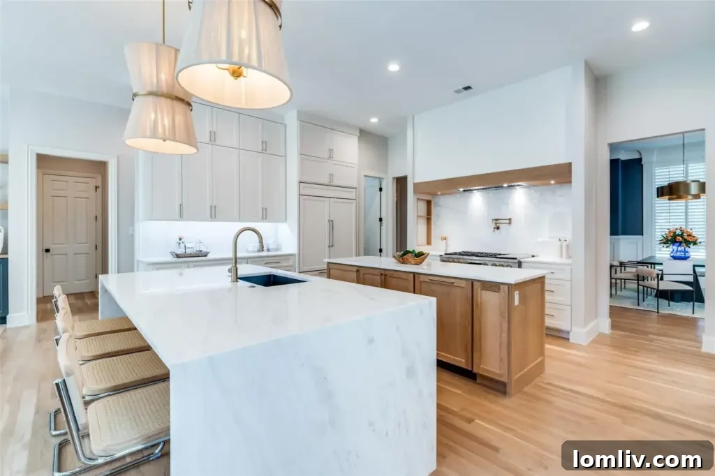 Gourmet kitchen with two islands, marble countertops, and high-end appliances in a Southlake luxury home