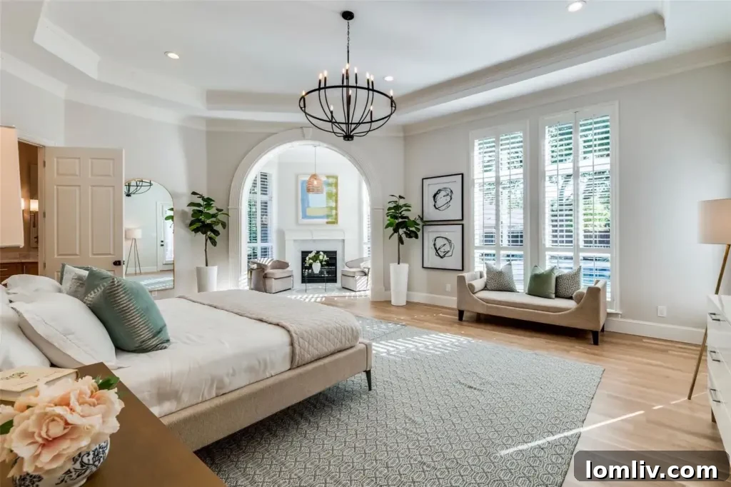 Luxurious primary bedroom with a private sitting area, fireplace, and direct backyard access