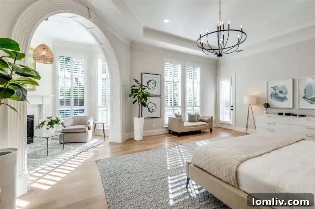Elegant primary bedroom showcasing custom shutters, ample natural light, and refined decor