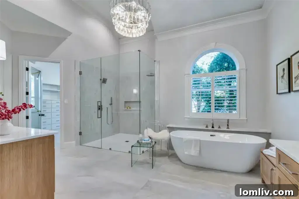 Spa-like primary ensuite bath with a 71-inch soaker tub, zero-entry shower, and marble floors