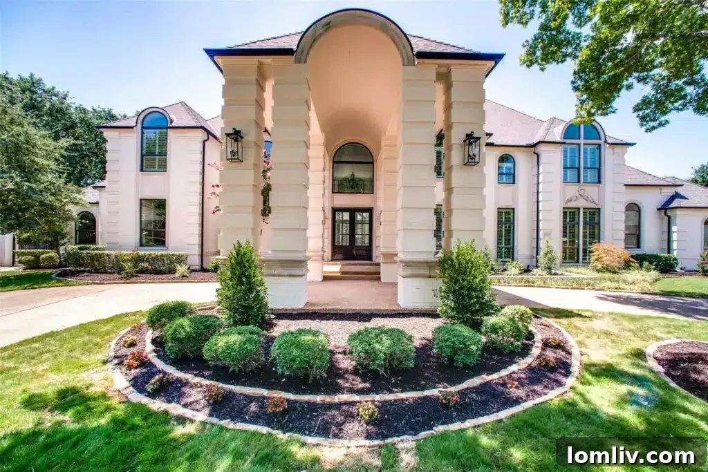 Luxurious entryway with designer lighting and herringbone wood floors in a Southlake home