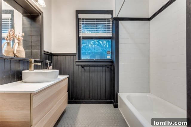 Modern bathroom featuring black beadboard, white walls, and light wood grain accents
