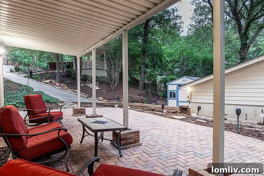 Multi-level backyard with natural landscaping and outdoor living spaces at 218 Scenic Drive