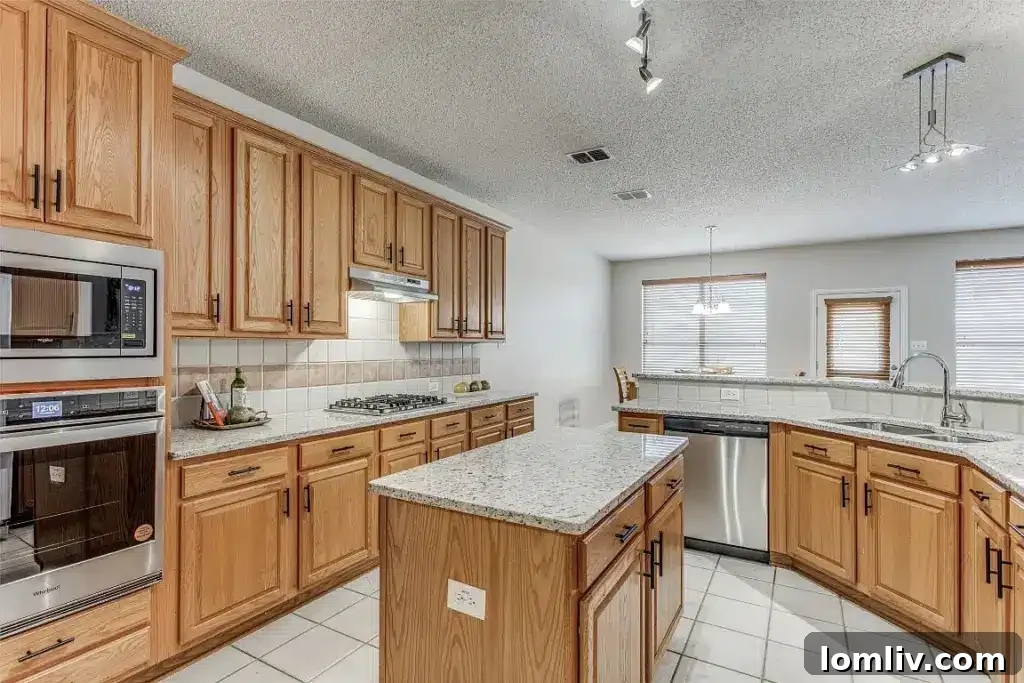Modern kitchen with island and stainless steel appliances at 3223 Newhaven Drive