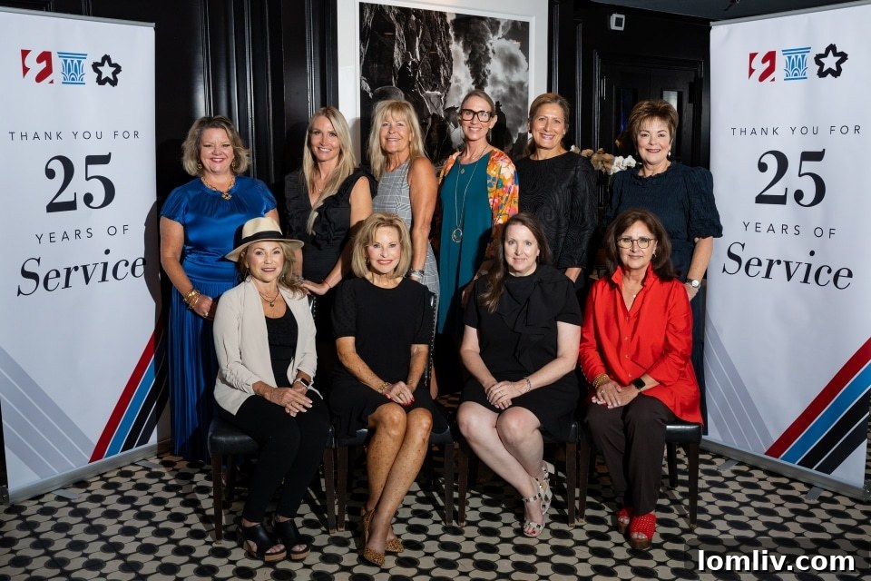 Group photo of Ebby Halliday Companies staff and agents celebrating their 25 years of service, smiling and standing together. The image captures the camaraderie and shared success within the company.