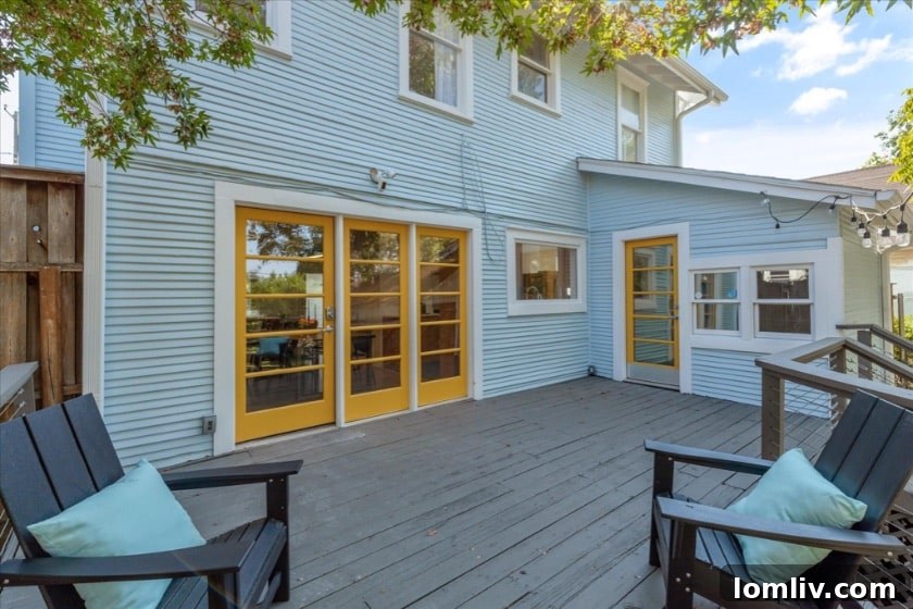 A charming and spacious front porch, decorated with potted plants, overlooking the tree-lined street, embodying the community and outdoor living aspect of Kings Highway homes.
