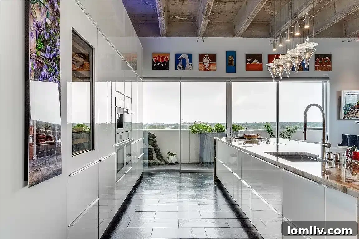 A sleek kitchen sink with breathtaking panoramic views of the Dallas cityscape from a high-rise condominium.