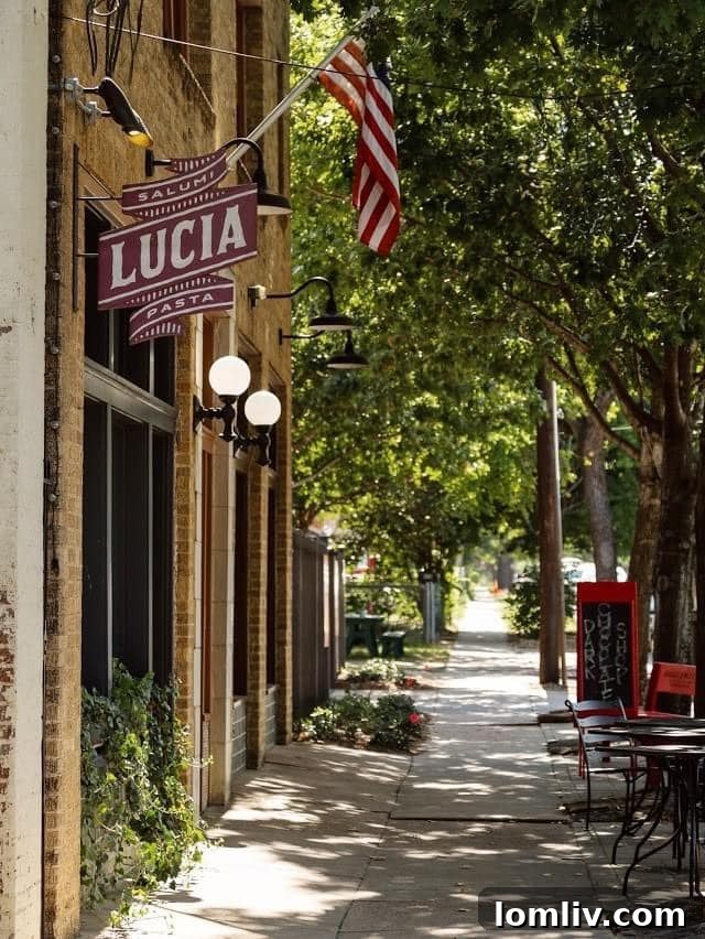 A charming street scene in Bishop Arts District, featuring trees, cafes, and pedestrians.