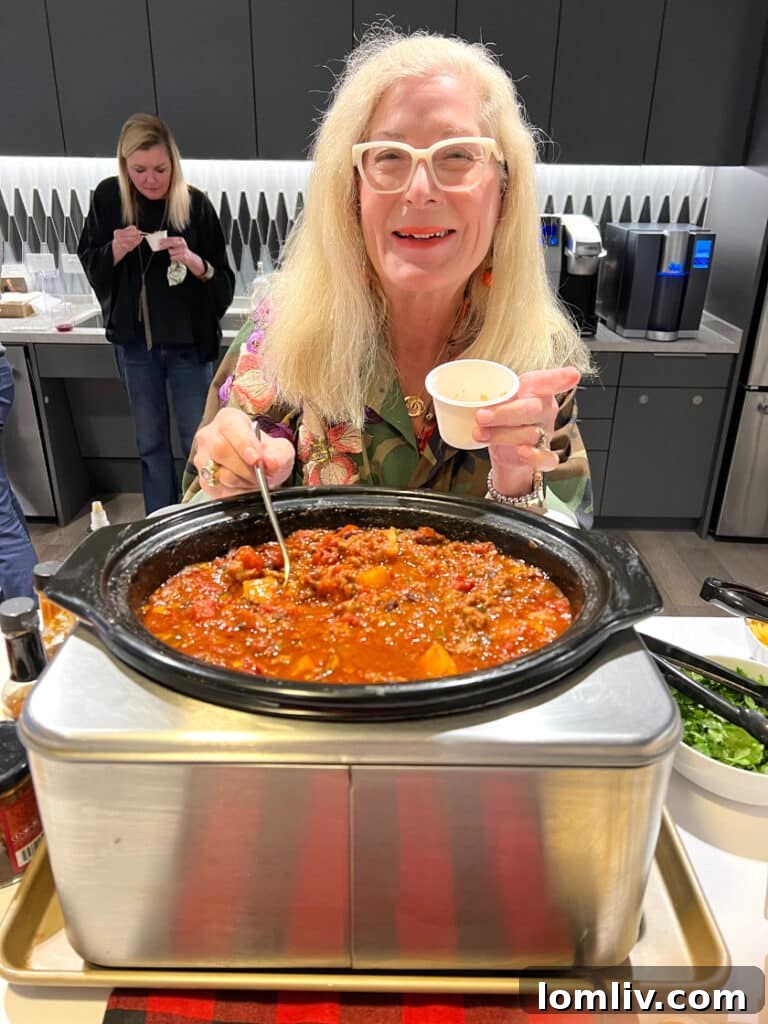 Candy Evans, the chili judge, carefully evaluating entries at the Briggs Freeman Sotheby’s International Realty chili cook-off.