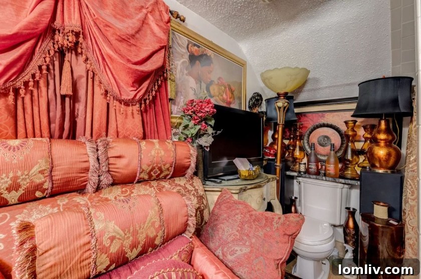 Another view of the master bathroom showcasing plush chair, pillows, and draperies