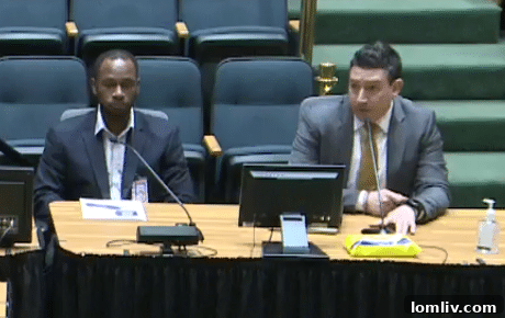 Interim Environmental Manager Isaac Ellison and Aviation Director Patrick Carreno speaking at a meeting.