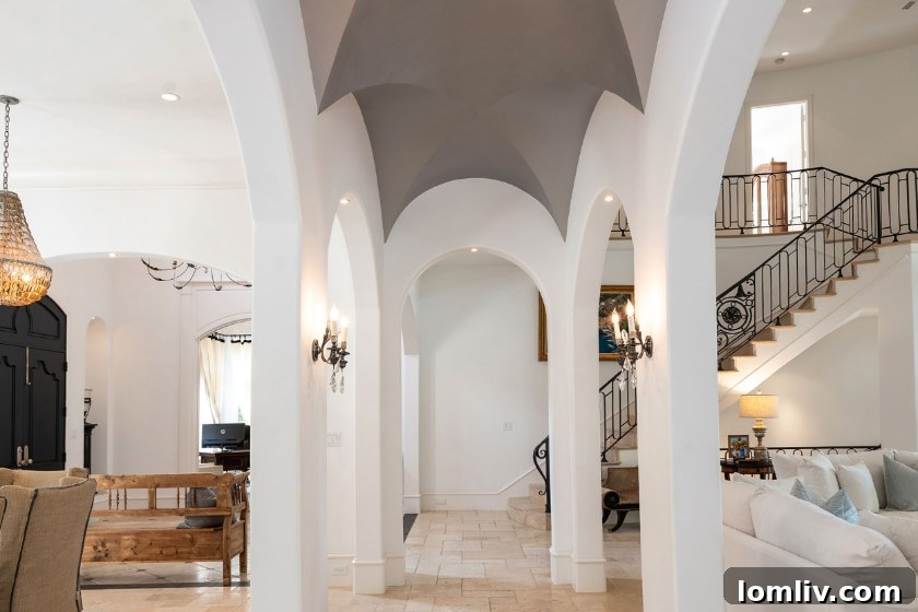 Formal Dining Room with Arched Entryway and Elegant Chandelier