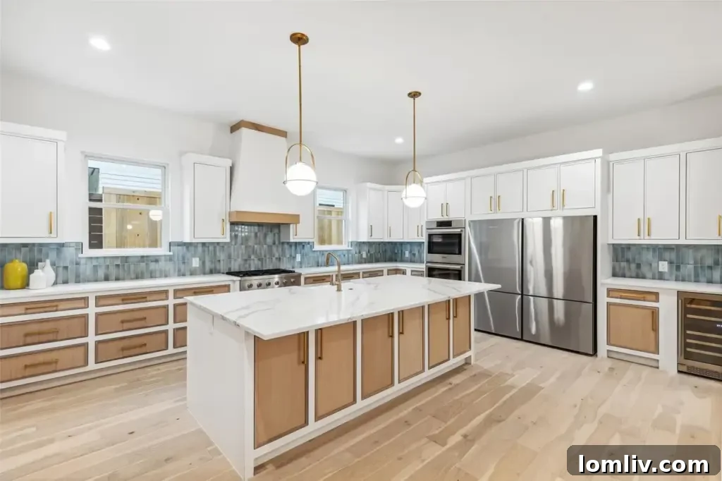 A sleek, bright, and organized kitchen with white oak cabinetry, quartz countertops, and high-end appliances.