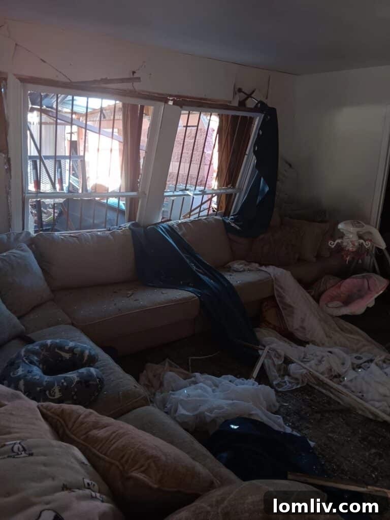 Family Displaced by Thanksgiving Gas Explosion in South Dallas 3 The living room of the South Dallas home, usually a family gathering spot, lies in wreckage after the gas explosion, showing the extensive interior damage.