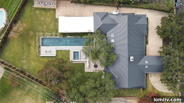 Lush landscaping, mature trees, and a sparkling pool at 6101 Merrymount Road, Westover Hills.