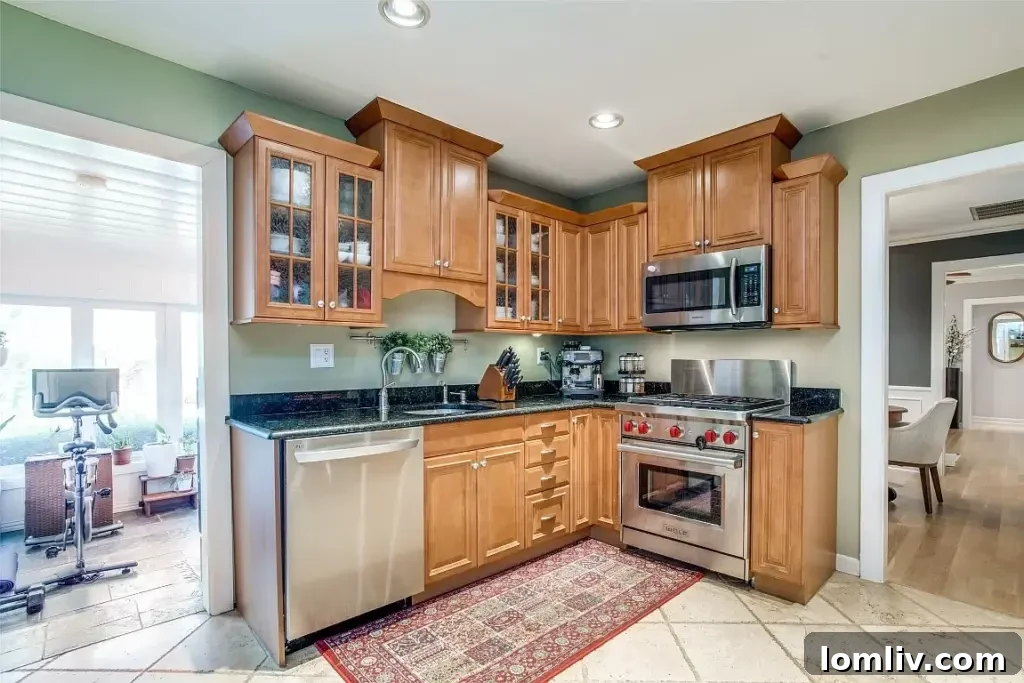 Modern and bright kitchen with granite countertops, stainless steel appliances, and ample cabinetry for storage.