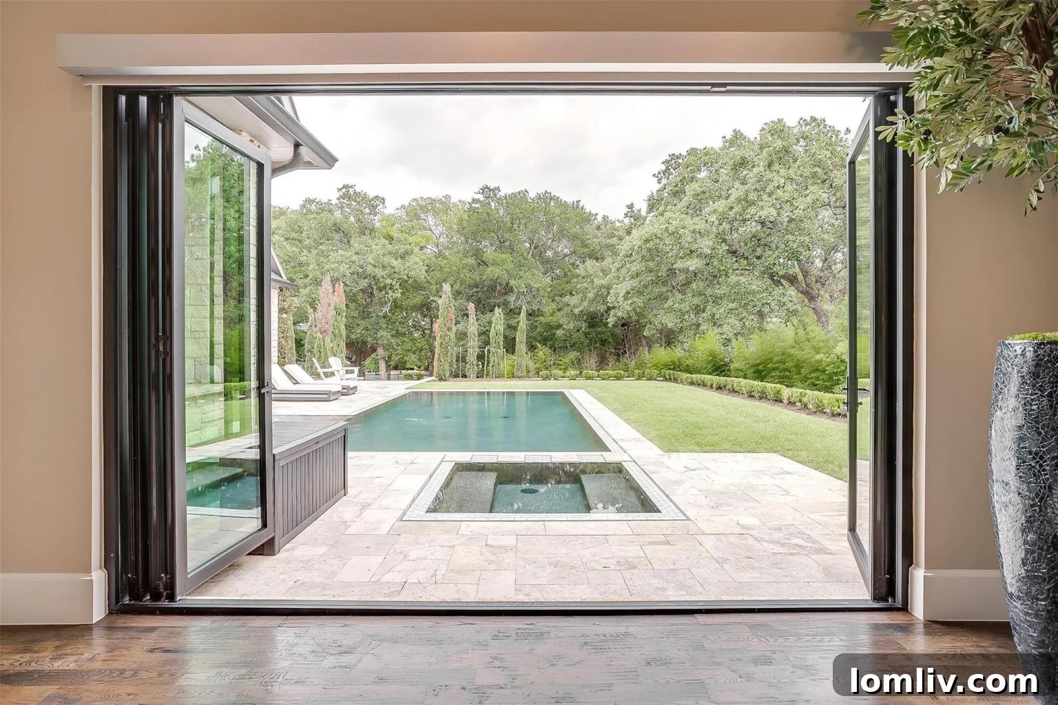 Doors opening to an impressive pool setting