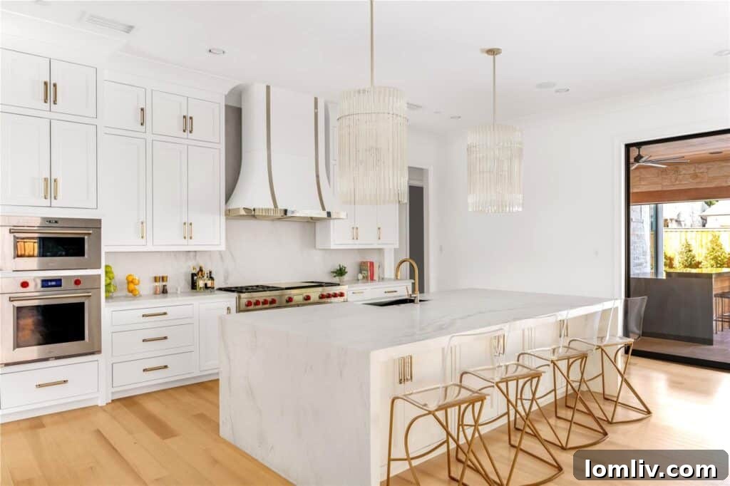 Gourmet kitchen with marble waterfall island and Wolf Sub-Zero appliances