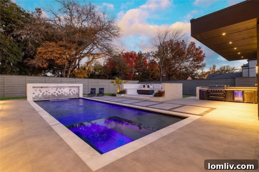 Modern pool with elegant marble seating and firepit