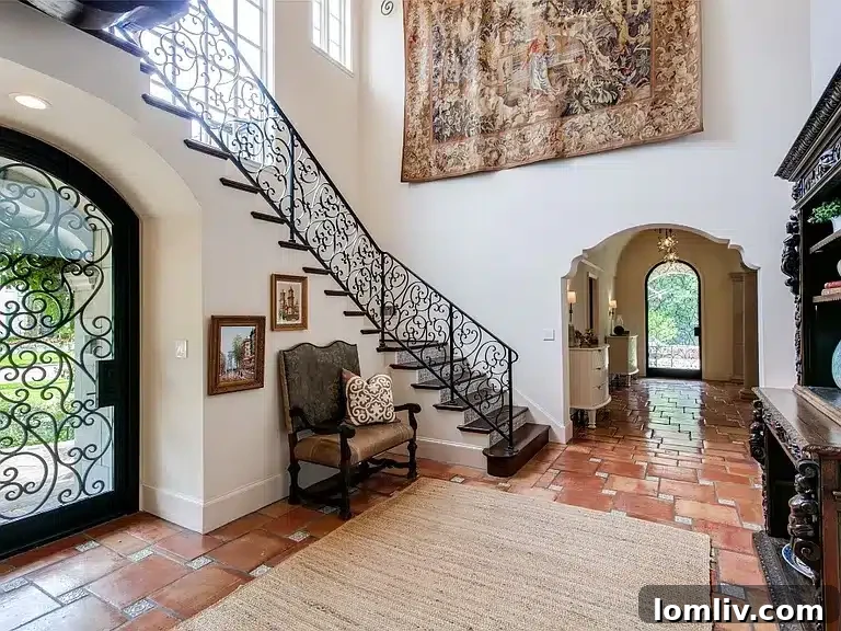 Intricate custom ironwork on the front door and staircase in the foyer
