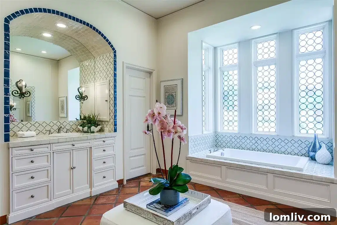 Bathroom showcasing tilework highlighting the home’s arches