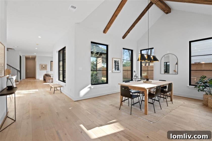 A stunning living room featuring a modern fireplace, high ceilings, and an abundance of natural light, characteristic of 5West Homes' designs.